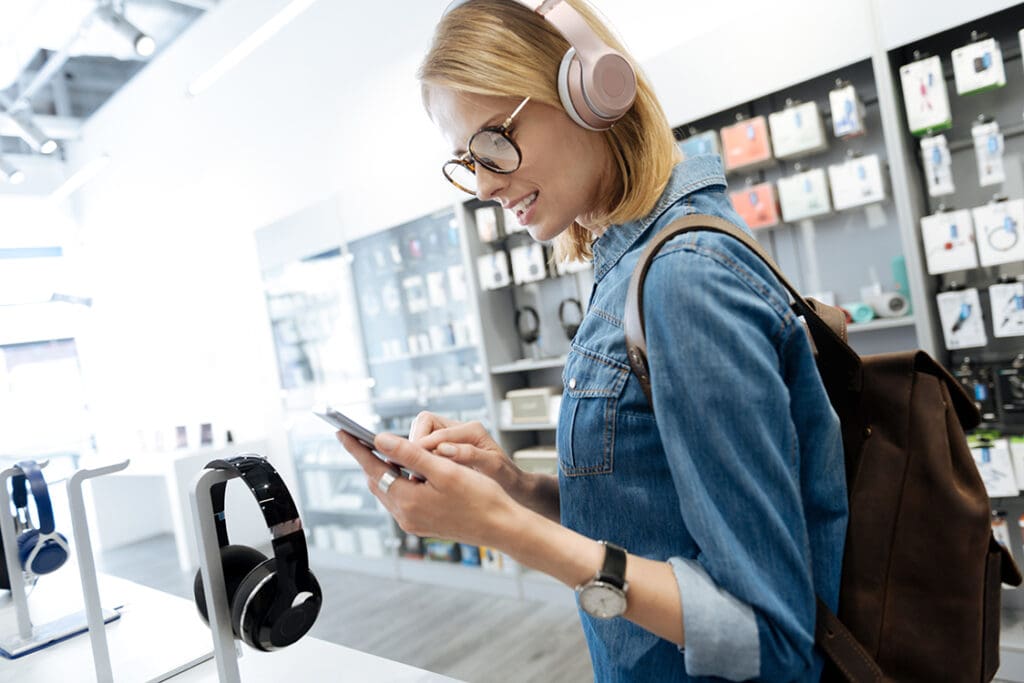 a woman interacts with a headphone display