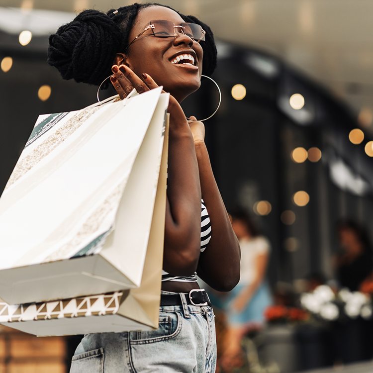 a woman is excited for holiday shopping
